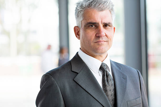 istock serious senior businessman close up portrait 512128447