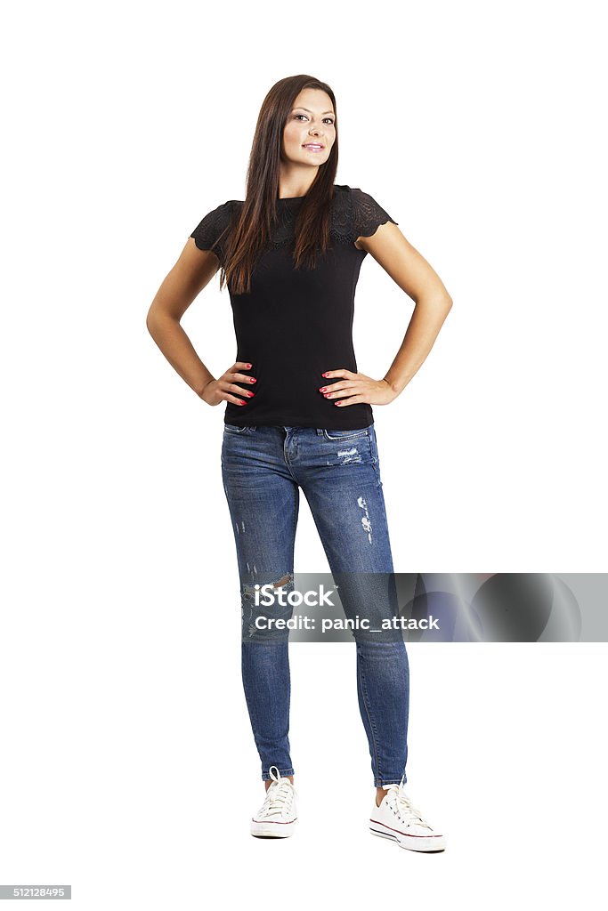 Beautiful young woman posing with arms on her hips Beautiful young brunette woman posing with arms on her hips. Full body length isolated over white. Women Stock Photo