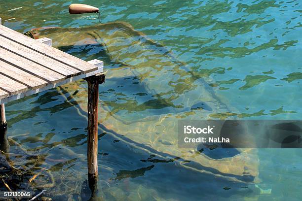 Old Rowing Boat Under Water At A Wooden Jetty Stock Photo - Download Image Now - Leaking, Nautical Vessel, Abandoned