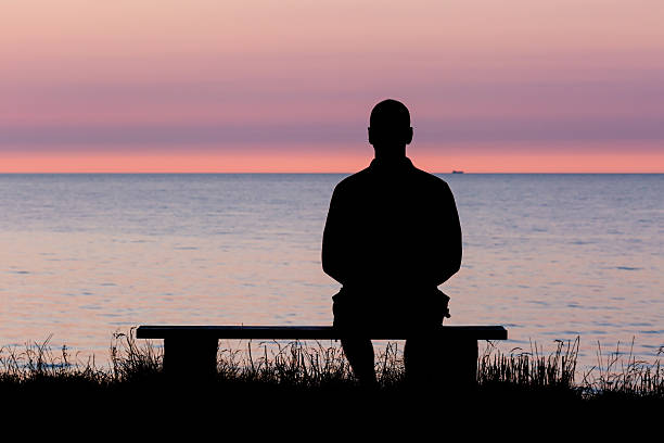 istock Silhouette of man on bench 512131741