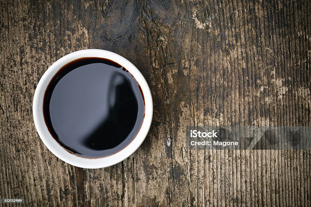 Balsamic vinegar Bowl of Balsamic vinegar on wooden table Balsamic Vinegar Stock Photo