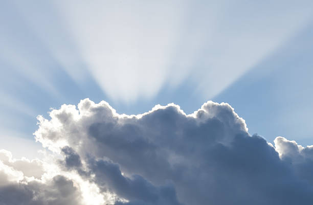 Fantastic sunbeams passing through dark storm clouds