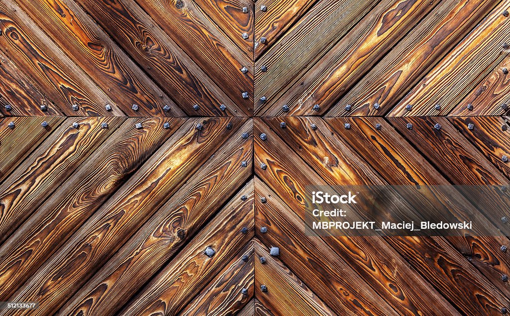 Wooden background with metal rivets, old gate of castle. Abstract Stock Photo