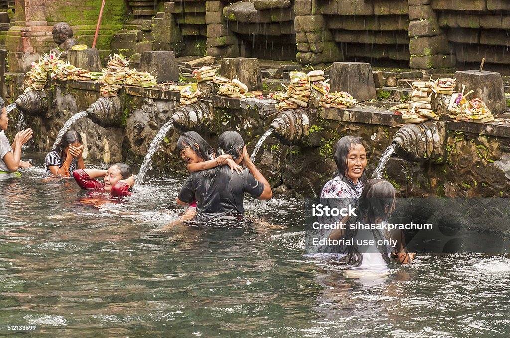 bali temple Bali, Indonesia, April 21,2010 : Balinese people praying at holy spring water in Pura Tirtha Empu templel during purification ceremony  in Tampak Siring, Bali, Indonesia.The traditional culture of Hindu religion in Bali. Asia Stock Photo