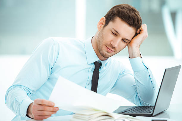 istock Young businessman in office with big window 512142116