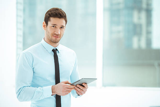 istock Young businessman in office with big window 512142494