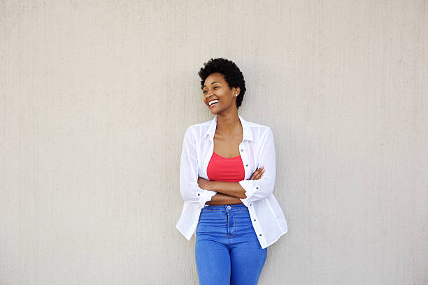 istock Smiling young african woman looking away 512144804