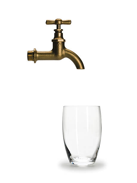 istock Glass for water and brass faucet 512146012