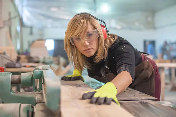 Photo of Female carpenter Using Electric Sander