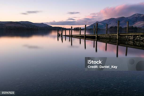 Jetty Reflections In Calm Lake With Pink Clouds In Sky Stock Photo - Download Image Now