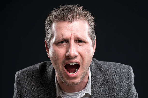 istock attractive angry businessman portrait shouting at camera 512149250