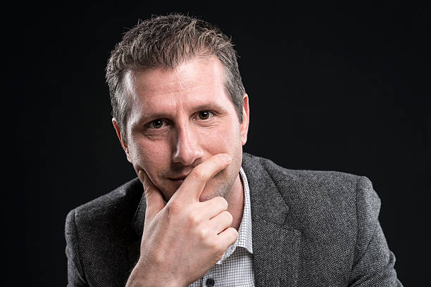 istock attractive businessman portrait looking pensive at camera 512149326