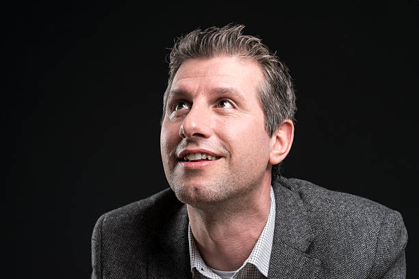 istock attractive businessman portrait looking up happy 512149398