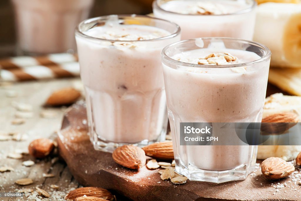 Smoothie with banana, yogurt, oatmeal and nuts Smoothie with banana, yogurt, oatmeal and nuts, selective focus Almond Stock Photo