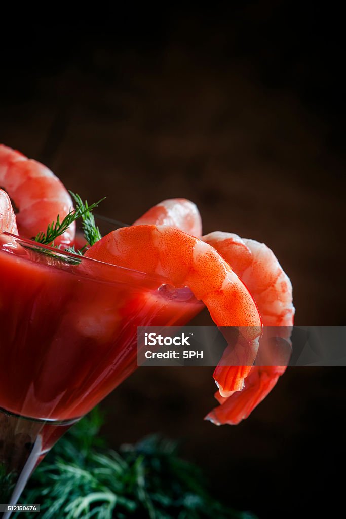 Shrimp cocktail in a martini glass, vegetables, spices Shrimp cocktail in a martini glass, vegetables, spices and herbs, selective focus Appetizer Stock Photo