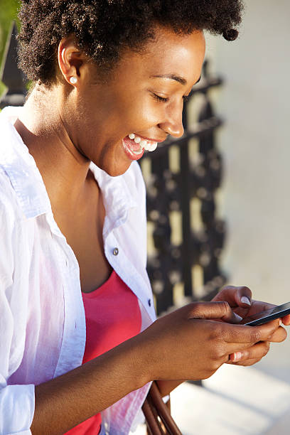istock Cheerful young woman using cell phone 512151610