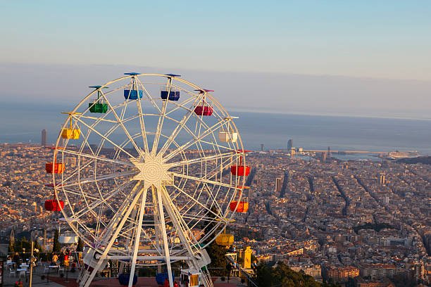 Barcelona, Tibidabo amusement park with ferris wheel Ferris wheel on top of the city, at Tibidabo, Barcelona ferris wheel stock pictures, royalty-free photos & images