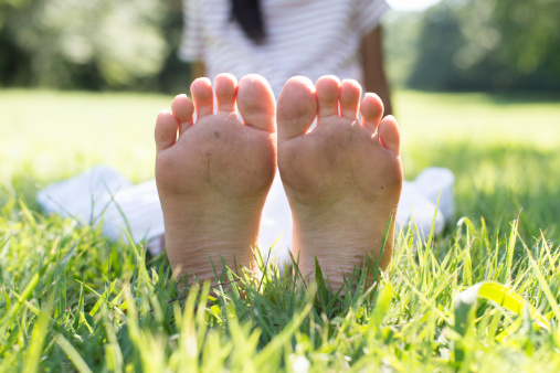 Legs and feet of a girl on grass