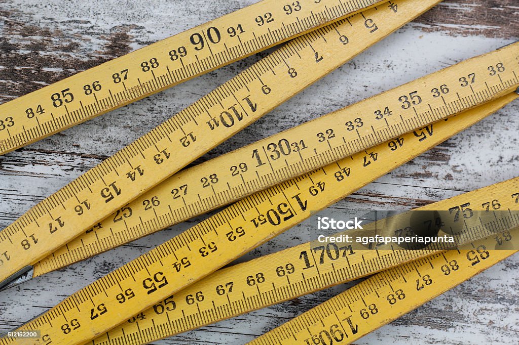 Wood measuring meter Wood measuring meter, in a wooden background Ruler Stock Photo