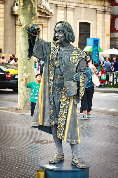 Barcelona, Spain - August 09, 2014: Street Performer imitating Christopher Columbus painted in golden and gray colors on famous La Rambla street, Barcelona, Spain