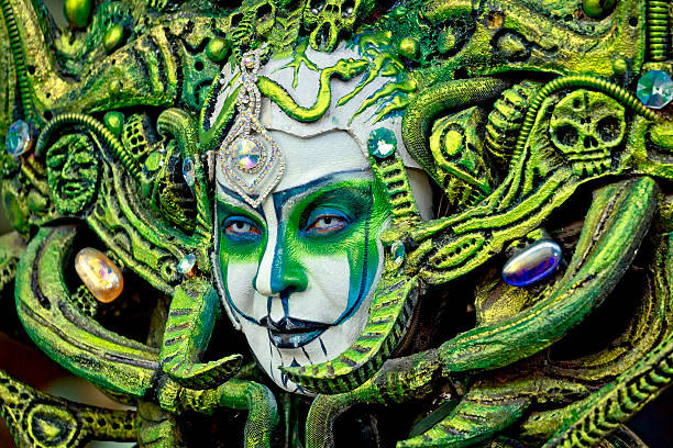 Barcelona, Spain - August 09, 2014:Woman street performer posing as mythical goddess of evil painted in white and green colors on famous La Rambla street, Barcelona, Spain