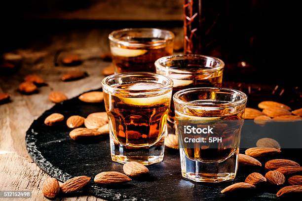 Brandy And Almonds Small Glasses Stock Photo - Download Image Now - Amaretto Liqueur, Whiskey, Almond