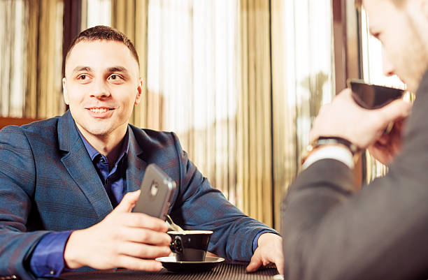 istock smiling businessmen meeting in cafe 512153356