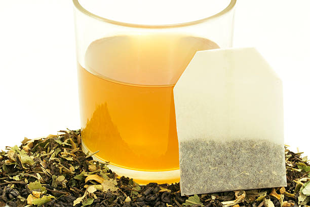 istock Glass cup of tea with some dried tea leaves. 512153578