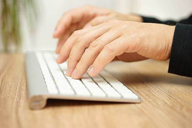 istock Closeup of male hands typing on computer keyboard 512153772