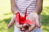 Girl holding a paper crane