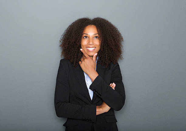 istock Confident young business woman thinking on gray background 512154587