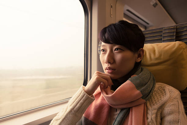 istock Young Asian Woman Traveling by Train 512154829