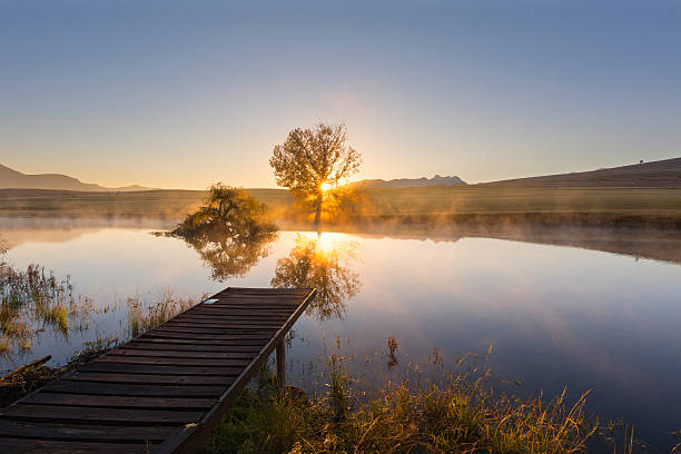 Sunrise over the water Sunrise over the water near Clarens, South Africa golden gate highlands national park stock pictures, royalty-free photos & images