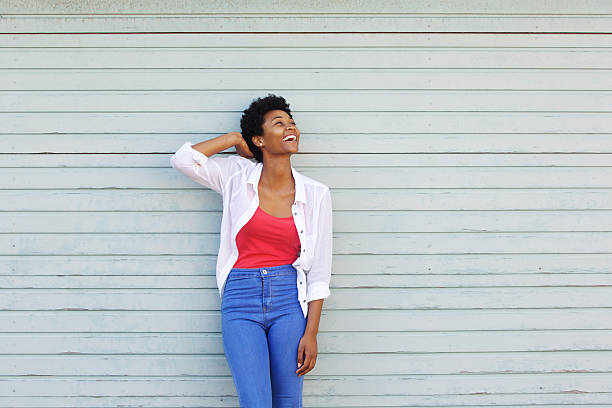 istock Cheerful young african woman looking up at copy space 512155468