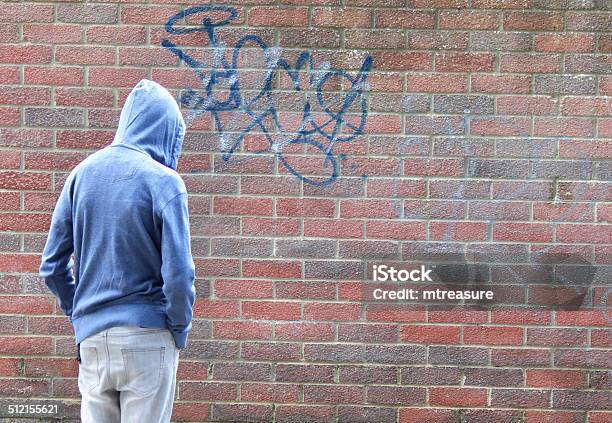 Image Of Teenage Boy Youth Wearing Hoodie Beside Graffiti Brickwall Stock Photo - Download Image Now