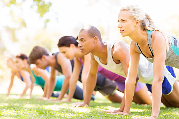 istock Row Of Friends Doing Push-Ups In Bootcamp 512156693