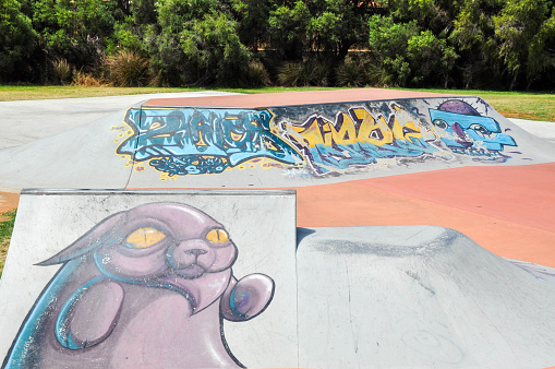 Spearwood,WA,Australia-January 5,2016: Banked concrete ramps, rails and spine with urban art at Spearwood Skate Park recreation location in Spearwood, Western Australia.