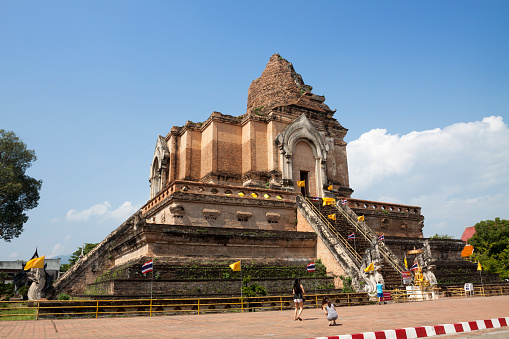 Chiang Mai, Thailand - October 28, 2015: Wat Chedi Luang buddhist temple in Chiang Mai Thailand. Dating from the 14th century this temple was severely damaged by an earthquake soon after it was finished in mid 15th century. Today it is a popular tourist attraction in this major city in northern Thailand.