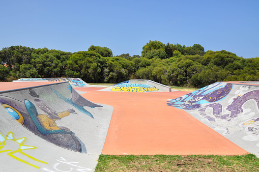 Spearwood,WA,Australia-January 5,2016: Spearwood Skate Park recreation area with concrete spine and banked ramps coloured with urban art and tagging in Spearwood, Western Australia.