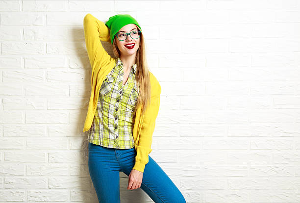istock Happy Hipster Girl at White Brick Wall Background 512158364