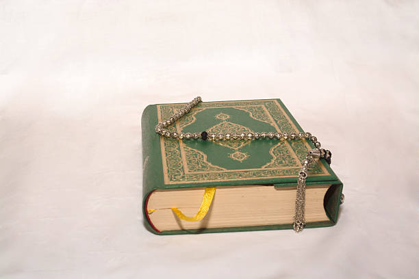 istock Koran and prayer beads on white background 512159116