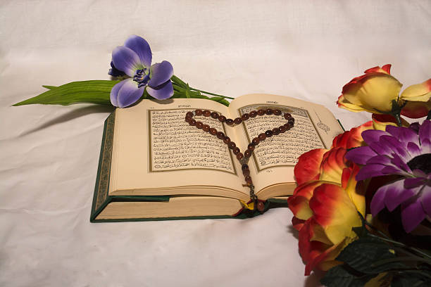 istock Koran and prayer beads with flowers on white background 512159212
