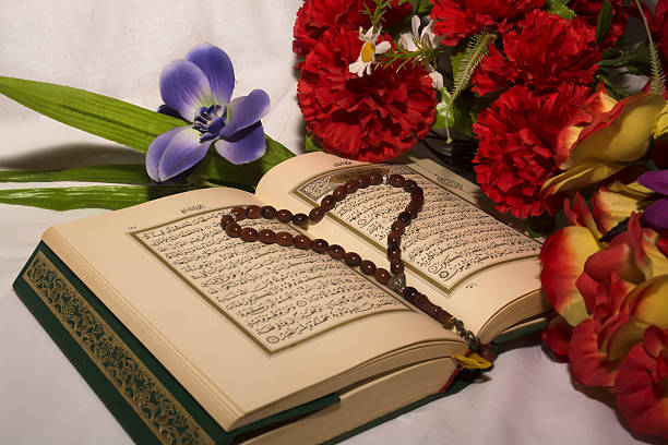 istock Koran and prayer beads with flowers 512159254