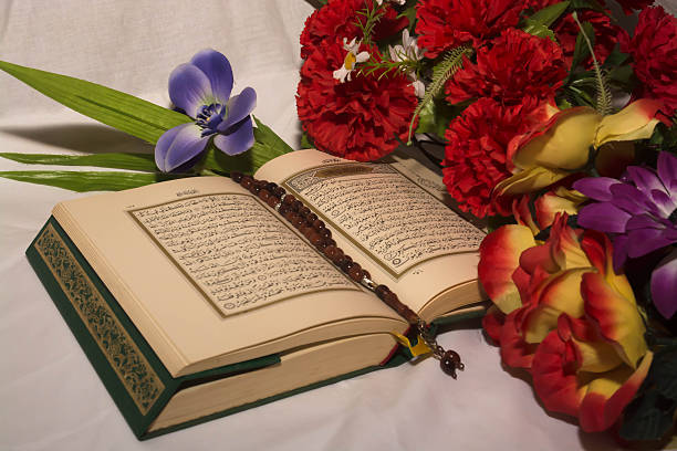 istock Koran and prayer beads with flowers 512159266