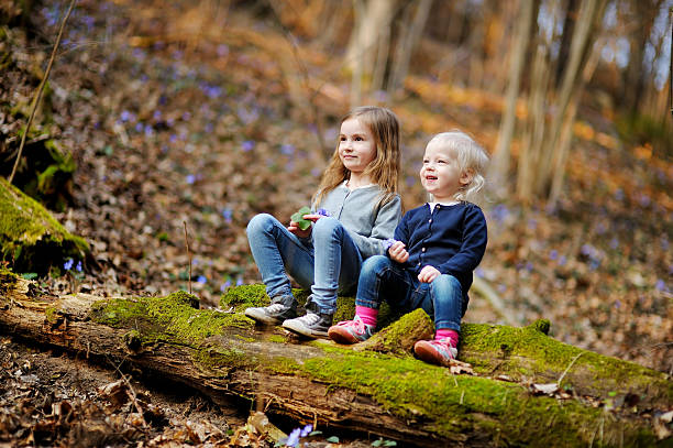 istock Two sisters picking the first flowers of spring 512164994