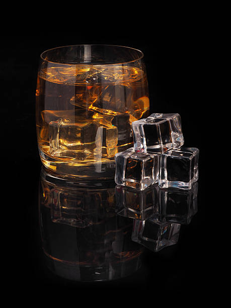istock glass of whiskey and ice on a black background 512165146