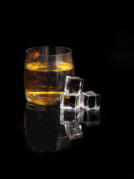 istock glass of whiskey and ice on a black background 512165154