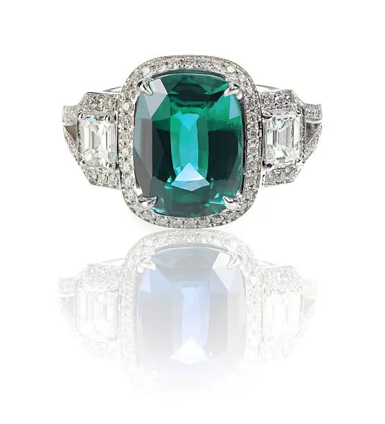 Blue Green Emerald Aquamarine precious gemstone and diamond ring precious gemstone and diamond ring isolated on white with a reflection