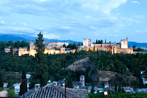 Granada, Andalucia, Spain - View of The Alhambra Palace at dusk. It is one of the most famous examples of Islamic architecture and one of the best preserved palaces in the world.