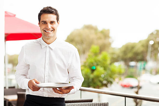 istock Confident Waiter With Serving Tray Smiling In Restaurant 512174311